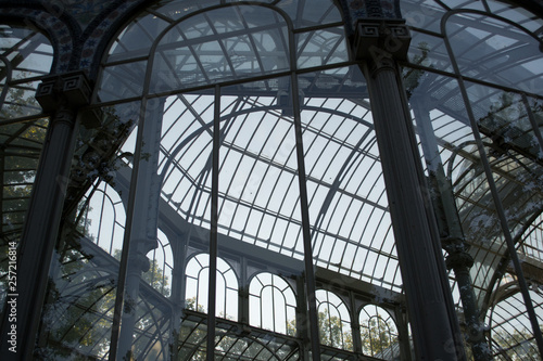 The Palacio de Cristal. "Crystal Palace" is a glass and metal structure located in Madrid Buen Retiro Park.