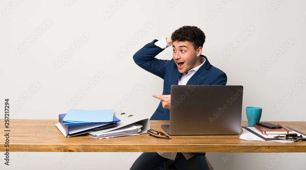 Business man in a office surprised and pointing finger to the side Business man in a office surprised and pointing finger to the side