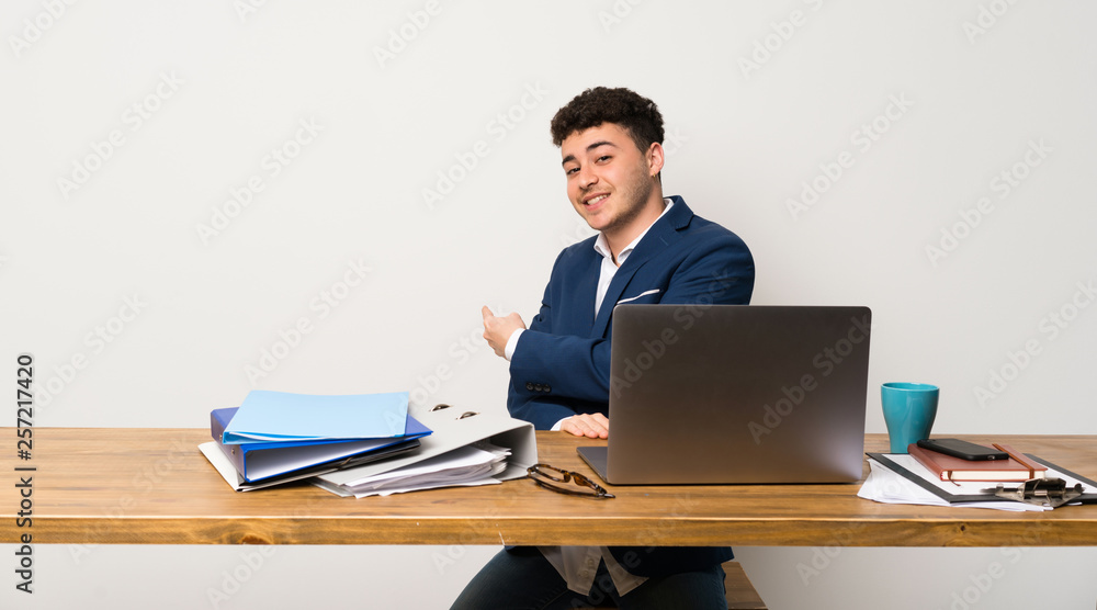 Business man in a office pointing back Business man in a office pointing back