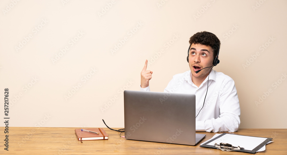 Telemarketer man pointing up and surprised Telemarketer man pointing up and surprised