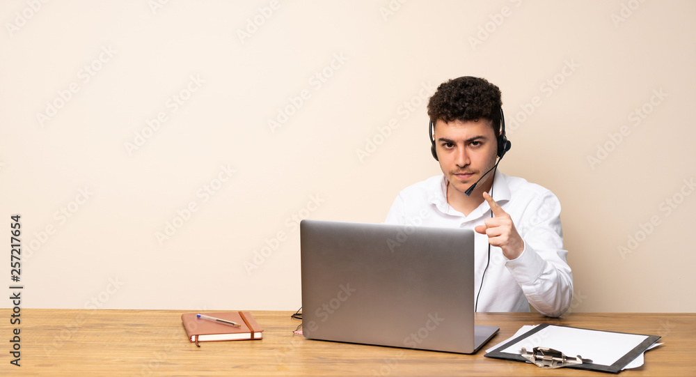 Telemarketer man frustrated and pointing to the front Telemarketer man frustrated and pointing to the front