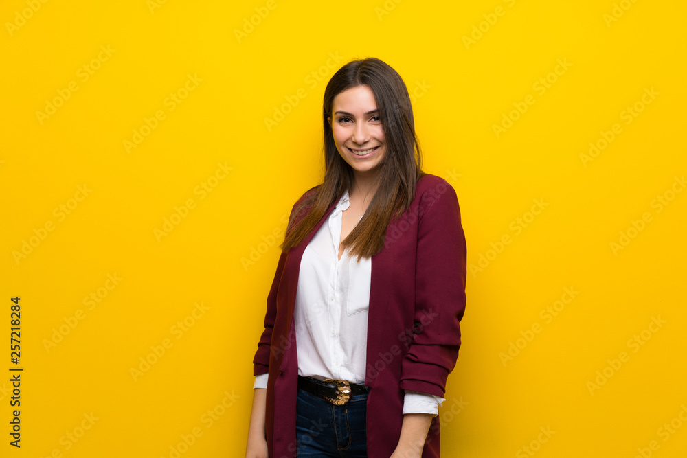 Young woman over yellow wall Young woman over yellow wall