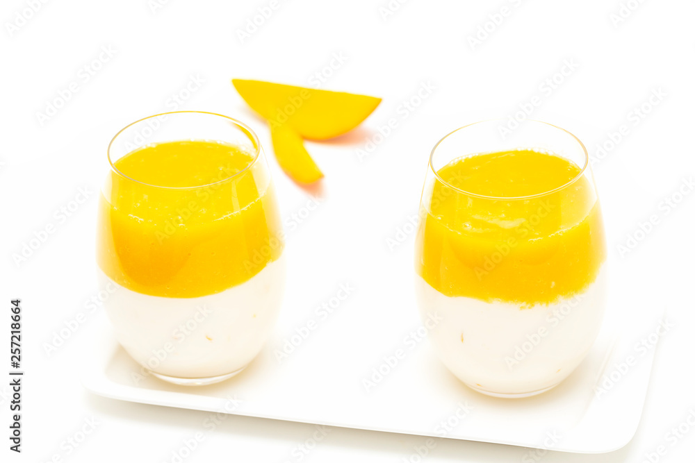 Fruit dessert with mango and mint over white background. Mango mousse. Italian dessert, homemade cuisine. Fruit dessert with mango and mint over white background. Mango mousse. Italian dessert, homemade cuisine.
