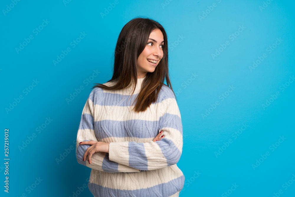 Young woman over blue wall Young woman over blue wall