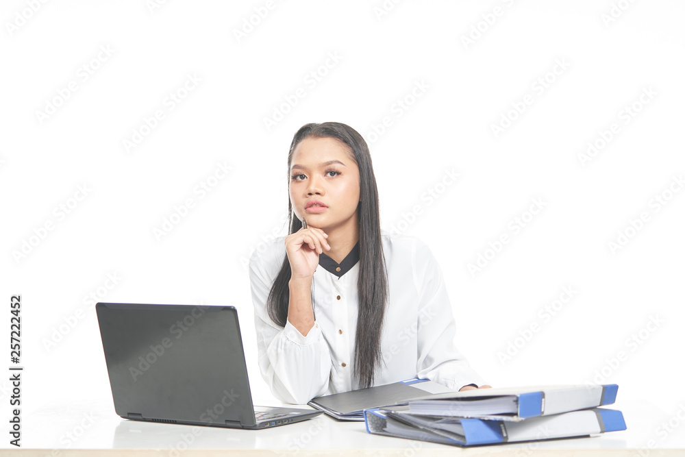 Office lady in white shirt and ponytail hair using a laptop and file Office lady in white shirt and ponytail hair using a laptop and file