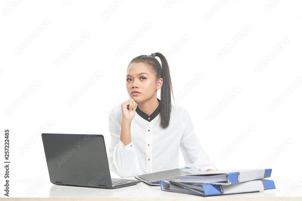 Office lady in white shirt and ponytail hair using a laptop and file Office lady in white shirt and ponytail hair using a laptop and file