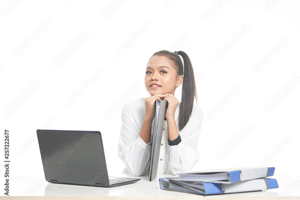 Office lady in white shirt and ponytail hair using a laptop and file Office lady in white shirt and ponytail hair using a laptop and file