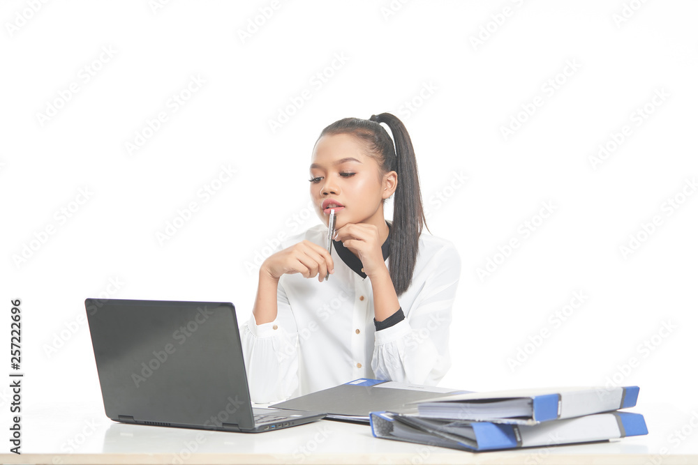 Office lady in white shirt and ponytail hair using a laptop and file Office lady in white shirt and ponytail hair using a laptop and file