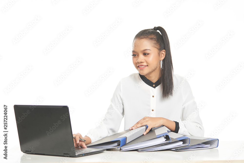 Office lady in white shirt and ponytail hair using a laptop and file Office lady in white shirt and ponytail hair using a laptop and file