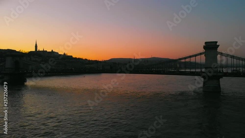 Aerial dolly shot to right of the Chain Bridge during sunset time over the Danube river photo