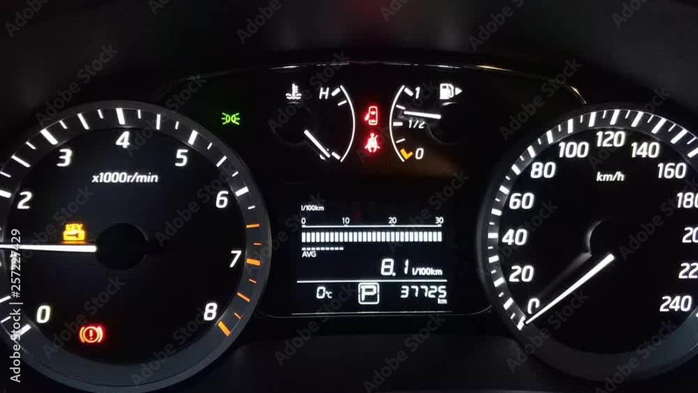 dashboard auto on a black background. Engine idling, alarm activated
