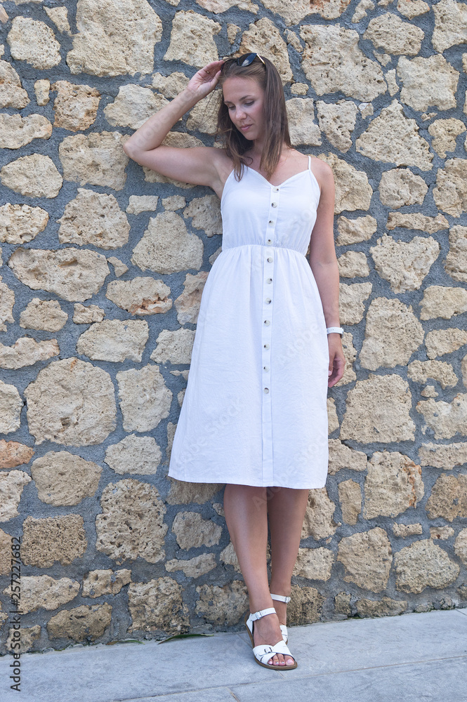 Young woman in white summer dress