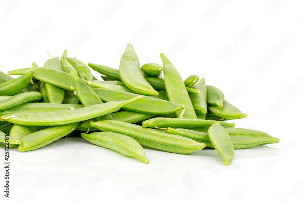 Lot of whole green sugar snap pea pods stack isolated on white background Lot of whole green sugar snap pea pods stack isolated on white background