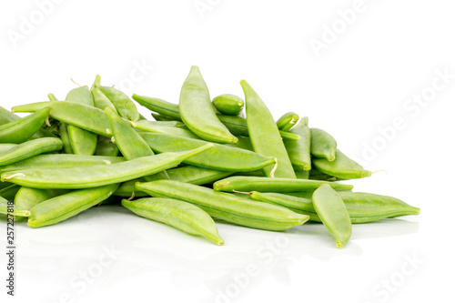 Lot of whole green sugar snap pea pods stack isolated on white background