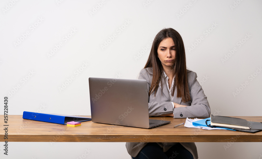 Business woman in a office feeling upset Business woman in a office feeling upset