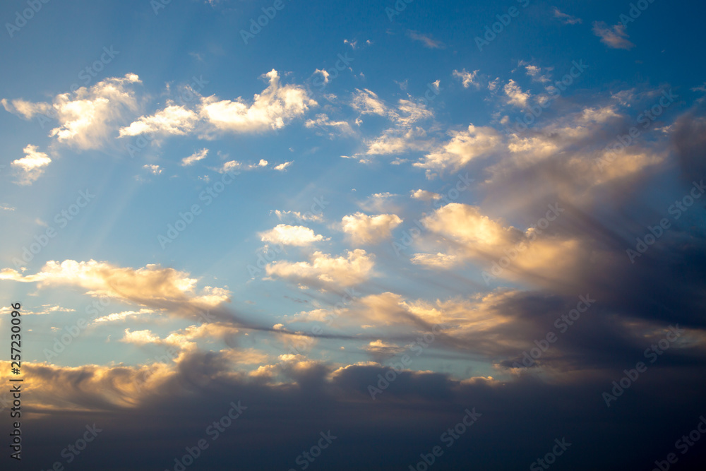 Bright blue sky with gentle cumulus clouds. Pink vanilla heaven. Natural summer and spring background.