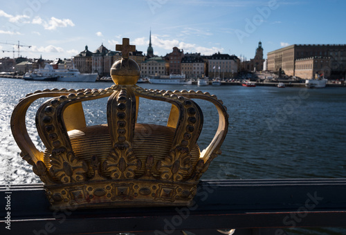 A sunny spring day in Stockholm, view over a pier with boats and birds at the city and old town photo