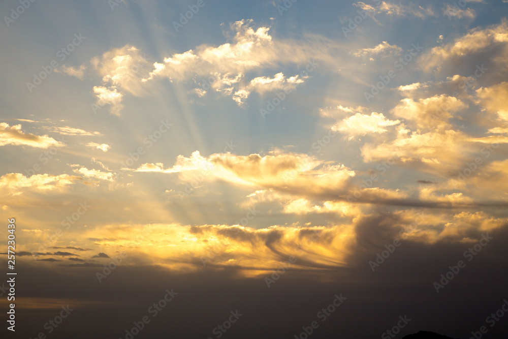 Fototapeta premium Bright blue sky with gentle cumulus clouds. Pink vanilla heaven. Natural summer and spring background.