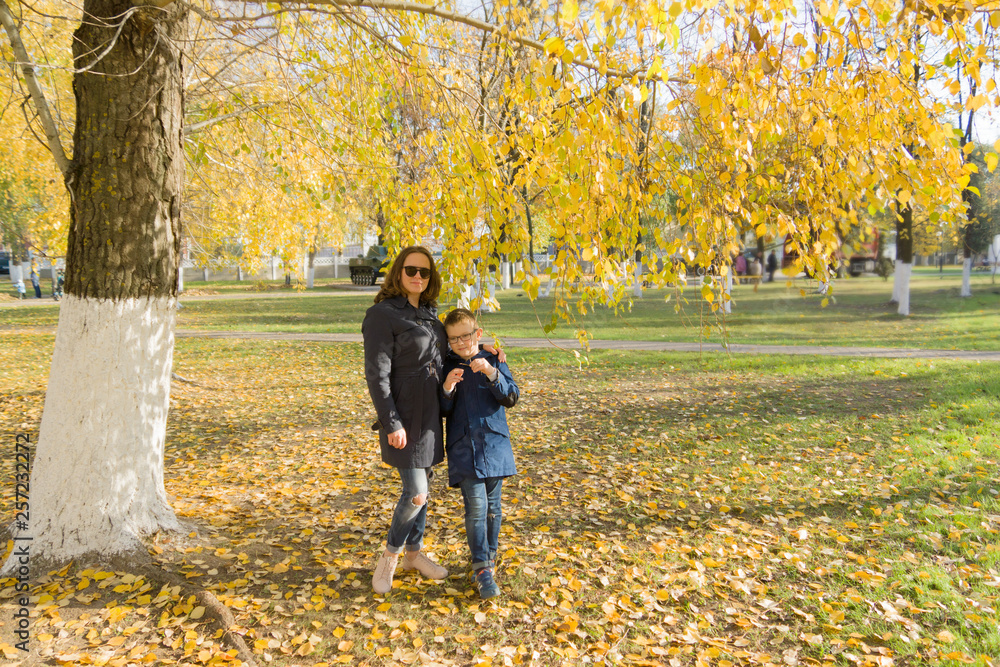 boy with mother walk in the autumn park boy with mother walk in the autumn park