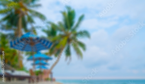 Fototapeta Naklejka Na Ścianę i Meble -  Beach, palm trees, sand, blue sky - a place for holidays and recreation. Soft focus background for lettering.