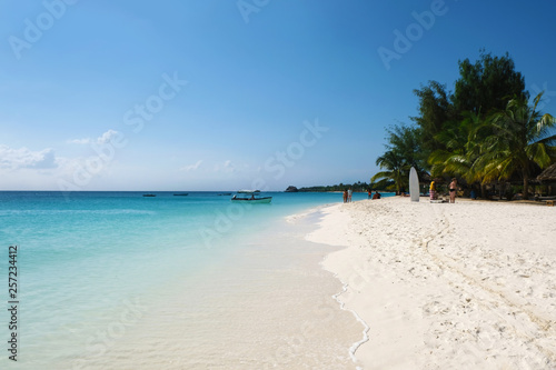 Fototapeta Naklejka Na Ścianę i Meble -  Amazing paradise ocean beach view People chilling on Zanzibar island