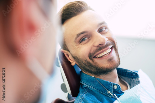 A perfect result of a dentist’s work which is seen in the beautiful and white smile on a patient who is absolutely satisfied with a result of a treatment given in a clinic.
