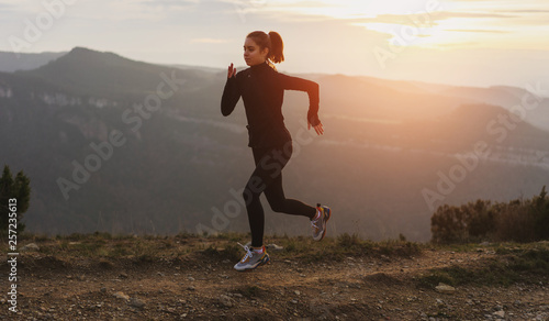 Sporty girl training outdoor wearing stylish sportswear at sunset