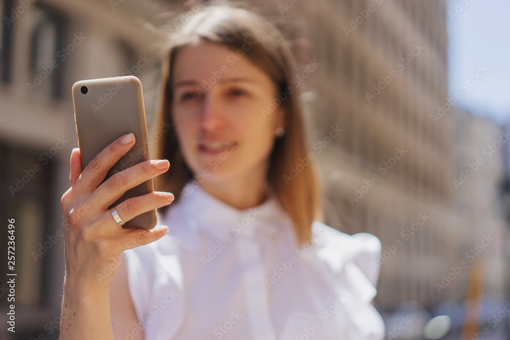 Close up of female hands using modern smartphone outdoor in sunny day, Happy smiling woman using smartphone device in downtown Close up of female hands using modern smartphone outdoor in sunny day, Happy smiling woman using smartphone device in downtown