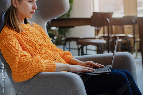 Young female manager using laptop while sitting at co-working, Business woman working on laptop in hotel lobby