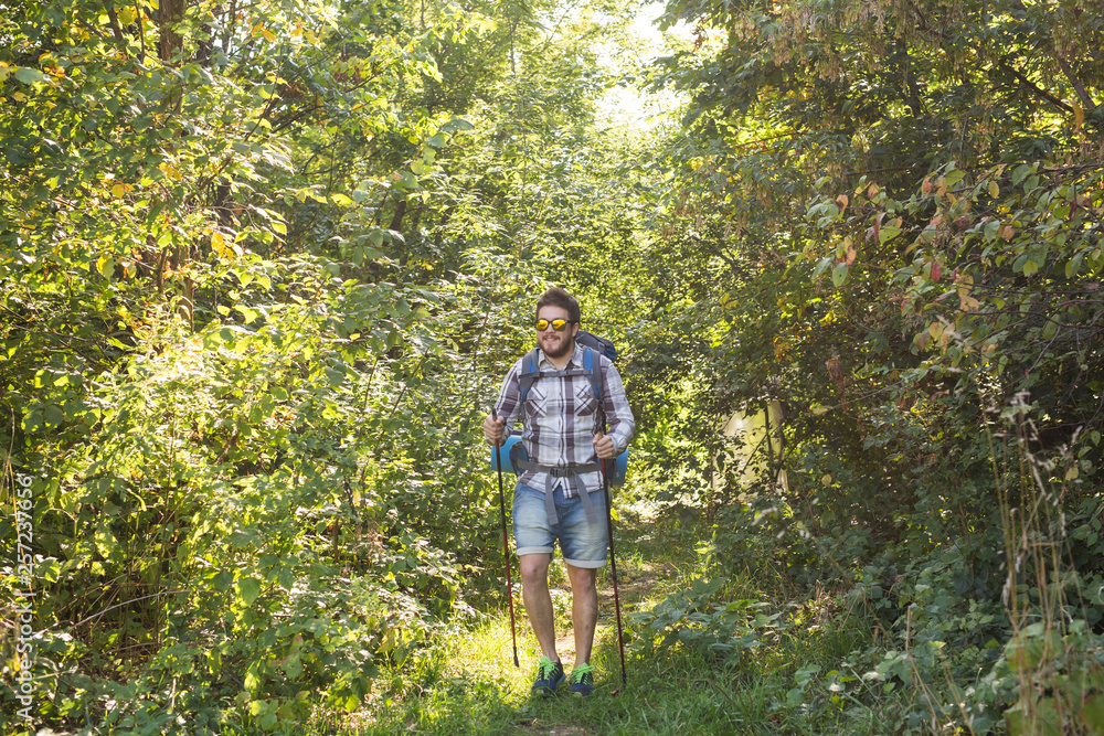 Adventures, summer tourism and nature concept - tourist arriving to a camping with his cat Adventures, summer tourism and nature concept - tourist arriving to a camping with his cat