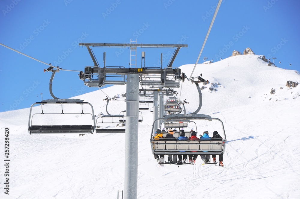 Chair lift view with people climbing to top of the ski slope, Chair lift view with people climbing to top of the ski slope,