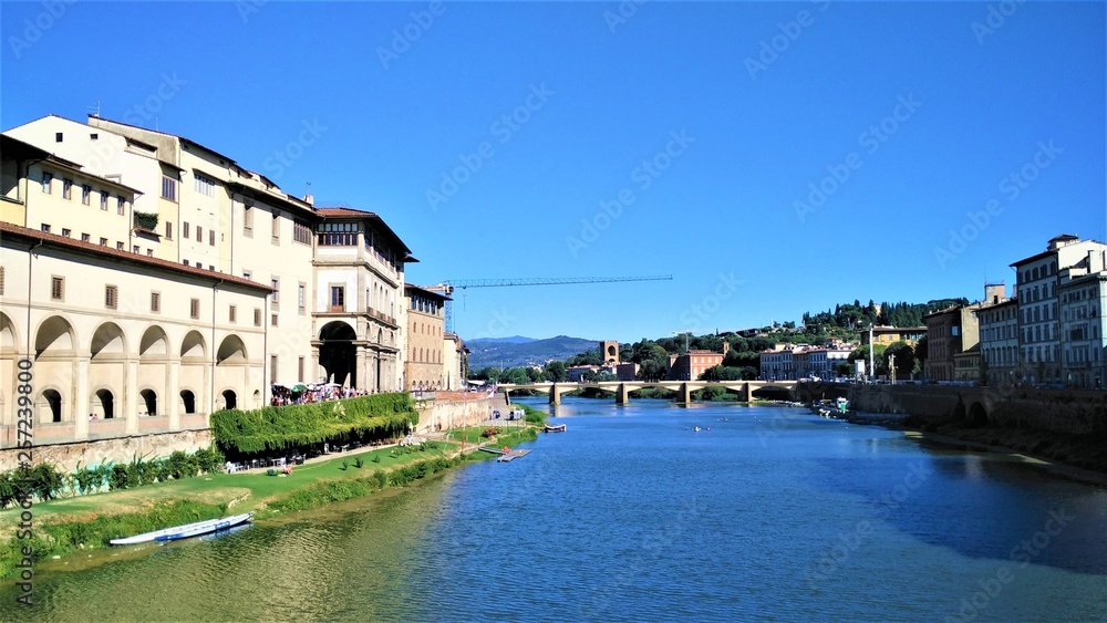 Bridge on green, blue river in Florence beautiful view of Florence, summer sunny day, blue sky, Italy 
