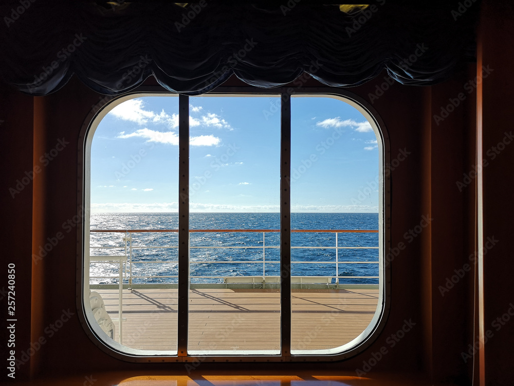 A view from the window of a cruise ship, showing the clear sky ocean.