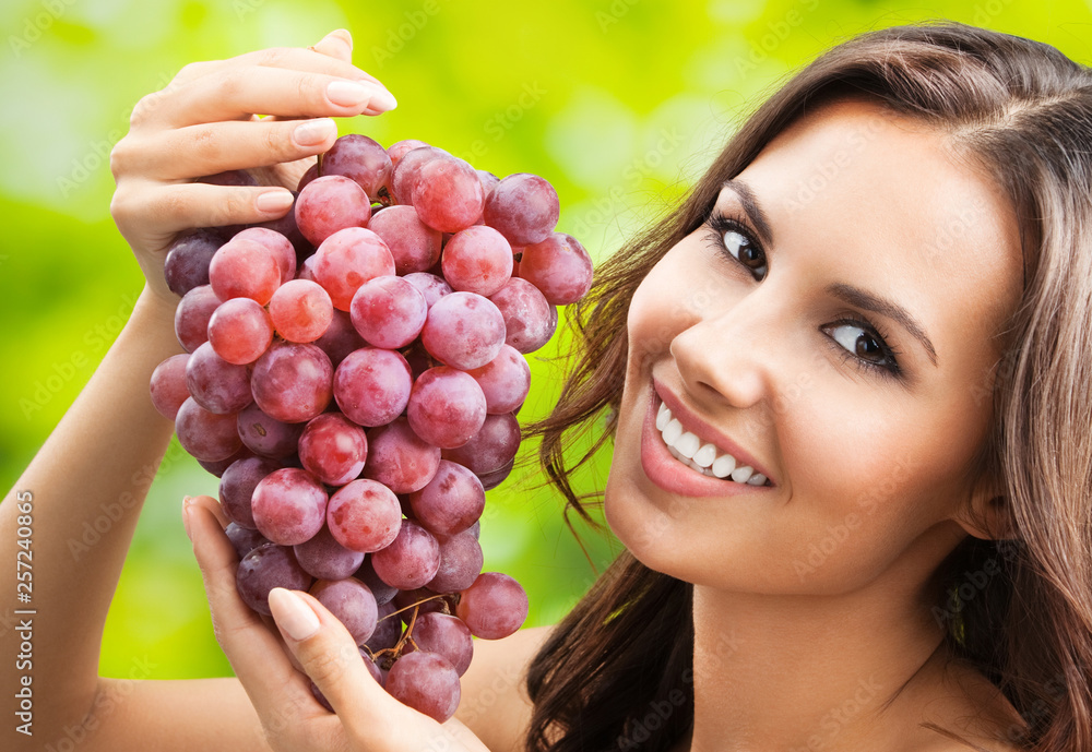 Young happy smiling woman with grapes, outdoors Young happy smiling woman with grapes, outdoors