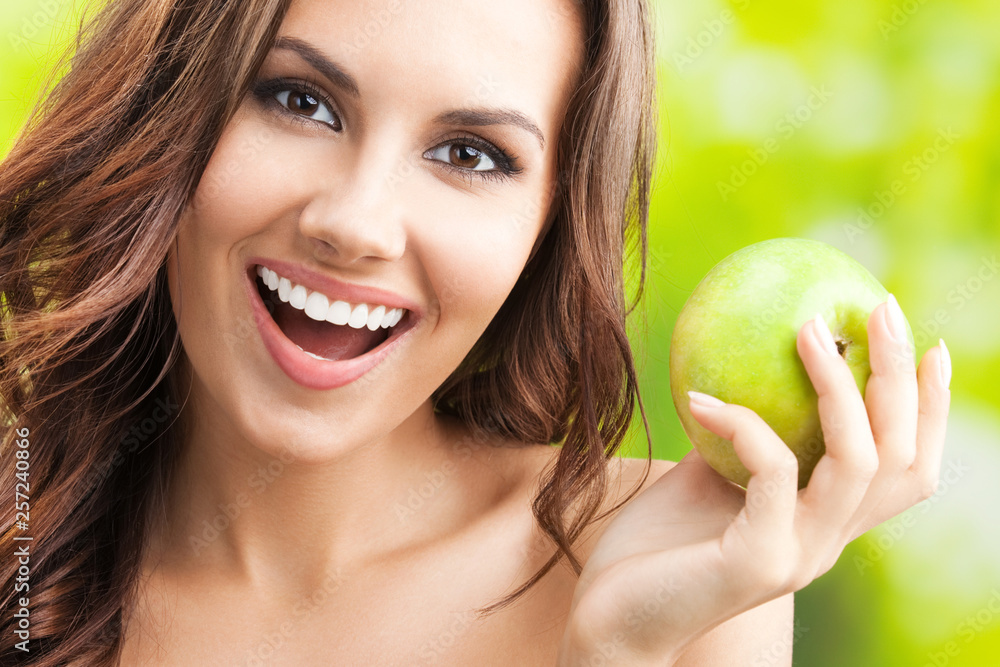 Young happy smiling woman with apple, outdoors Young happy smiling woman with apple, outdoors