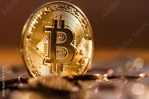 Golden Bitcoin close-up, it shines in the sun, it is valuable