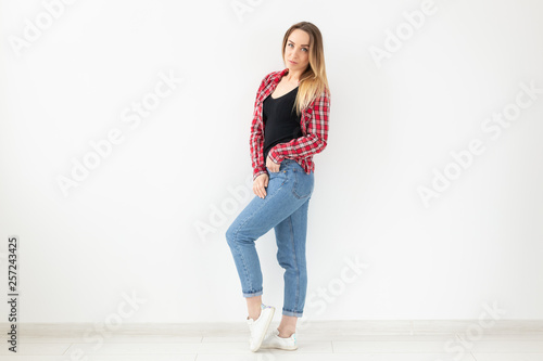 People and fashion concept - Full length image of woman posing sideways over white background