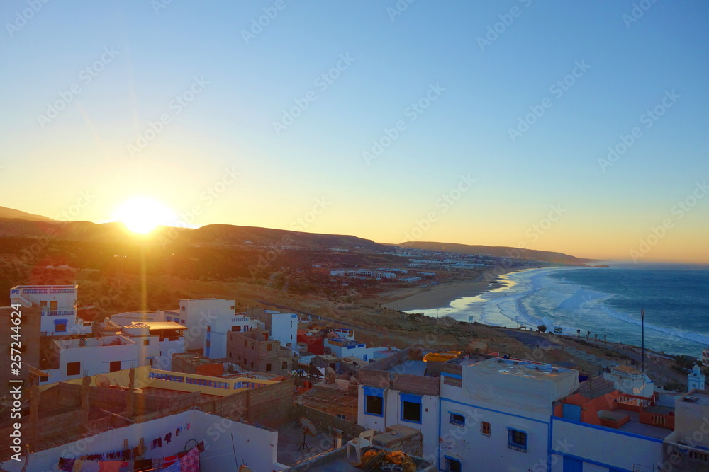 Sunrise over coastal village Taghazout in Southern Morocco known as surfing paradise near to Agadir