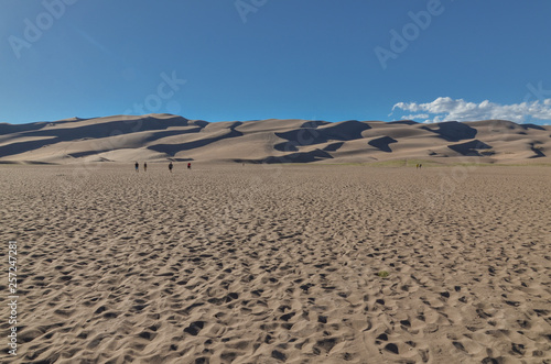 hikers at the foot of sand dunes in Great Sand Dunes National Park and Preserve (Saguache county, Colorado, USA) 