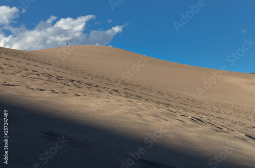 hiker at the top of dune in Great Sand Dunes National Park and Preserve (Saguache county, Colorado, USA)