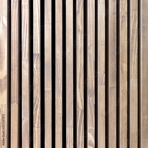 Texture wooden vertical stripes. Background natural tree with black stripes. Square size photo.