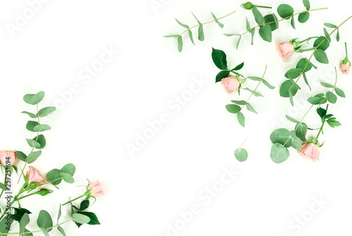 Flowers composition background. pink roses and eucalyptus leaves branches on white background top view. Floral card. Copy space