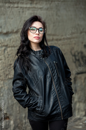 Beauty sexy fashion model woman portrait wearing glasses Elegant woman looking at camera in the black dress with glasses © romeof