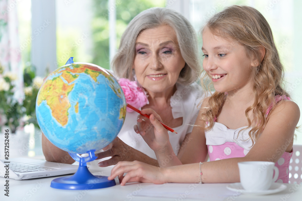Portrait of grandmother and granddaughter doing homework Portrait of grandmother and granddaughter doing homework