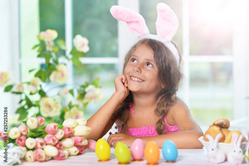 Portrait of little girl painting eggs for Easter holiday Portrait of little girl painting eggs for Easter holiday