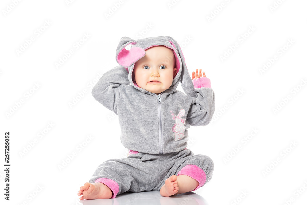 Happy Easter. The lovely girl with ears sitting on white background. baby emotions Happy Easter. The lovely girl with ears sitting on white background. baby emotions