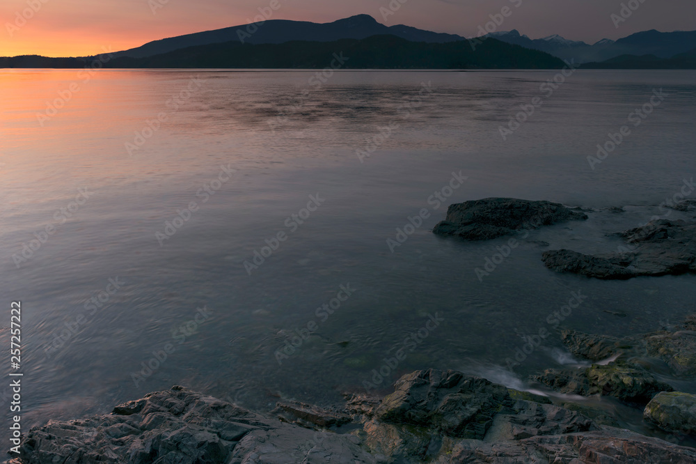 Stunningly beautiful sunsets of rocky beaches and mountains in beautiful British Columbia's Howe Sound on Bowen Island.