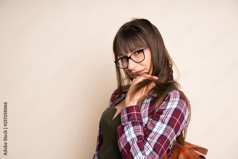 Young woman on ocher background laughing Young woman on ocher background laughing