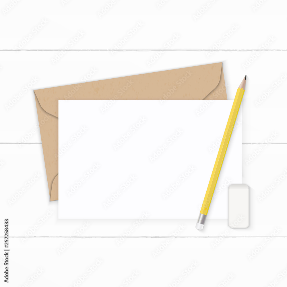 Flat lay top view elegant white composition letter kraft paper envelope yellow pencil and eraser on wooden background Flat lay top view elegant white composition letter kraft paper envelope yellow pencil and eraser on wooden background
