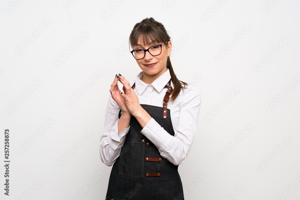 Young woman with apron scheming something Young woman with apron scheming something
